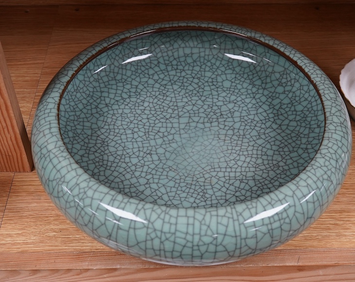 A large Chinese celadon crackle glazed shallow bowl, 35cm in diameter. Condition - good